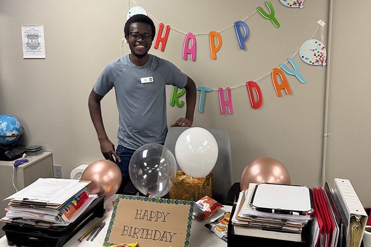 Student's decorated Davis's desk for his birthday David at his desk with birthday decorations